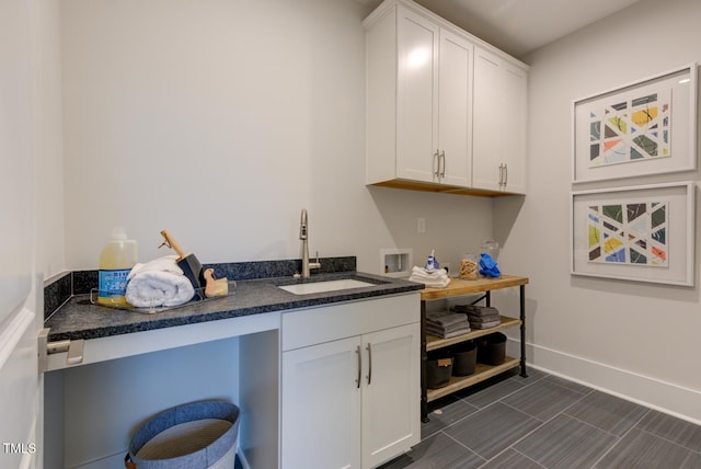 kitchen with white cabinetry and sink