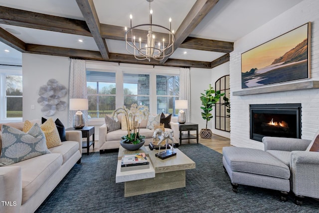 living room with beamed ceiling, dark hardwood / wood-style flooring, a fireplace, and a chandelier