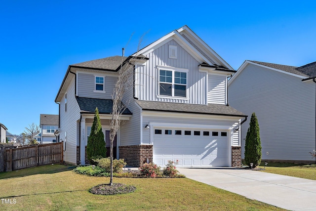 view of front of property featuring a front yard and a garage