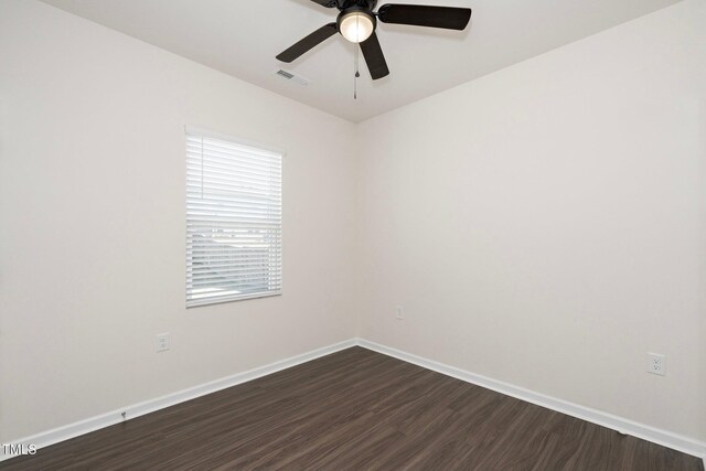 empty room with ceiling fan and dark hardwood / wood-style flooring