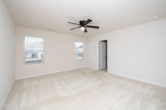 carpeted spare room with ceiling fan