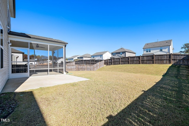 view of yard with ceiling fan, a patio, and a sunroom