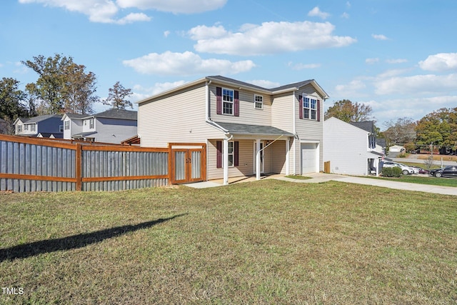 rear view of property featuring a yard and a garage