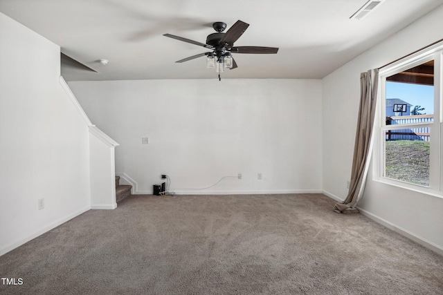 spare room featuring a wealth of natural light, carpet floors, and ceiling fan