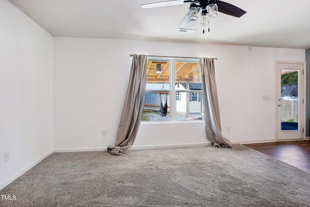 carpeted spare room featuring ceiling fan