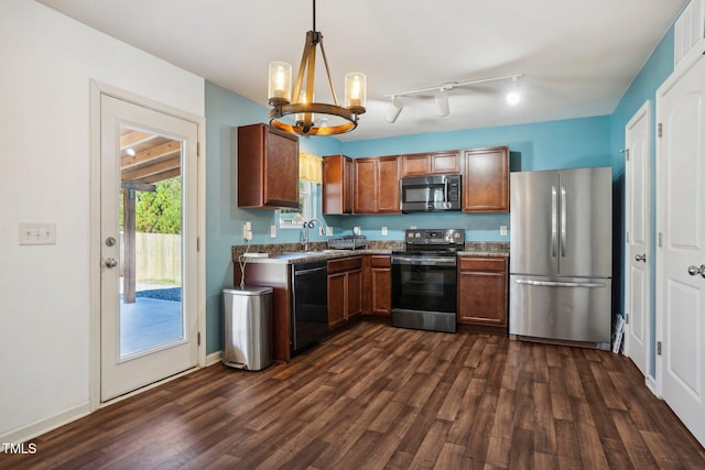 kitchen featuring a chandelier, appliances with stainless steel finishes, dark hardwood / wood-style flooring, and decorative light fixtures