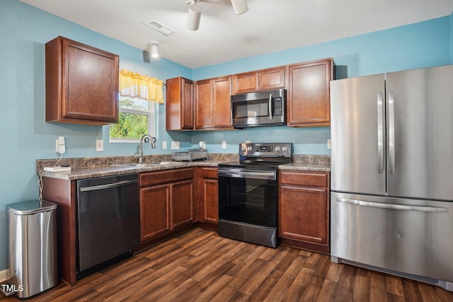 kitchen with ceiling fan, sink, appliances with stainless steel finishes, and dark hardwood / wood-style floors