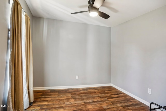 empty room with ceiling fan and dark hardwood / wood-style flooring