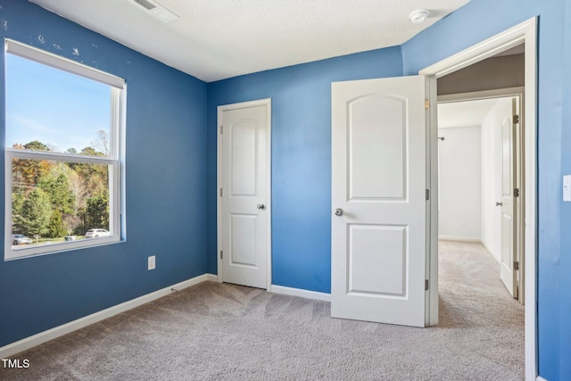 unfurnished bedroom featuring light colored carpet