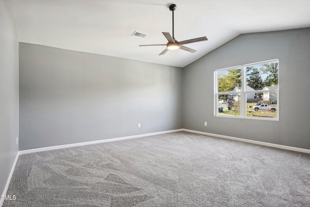 empty room with vaulted ceiling, carpet, and ceiling fan