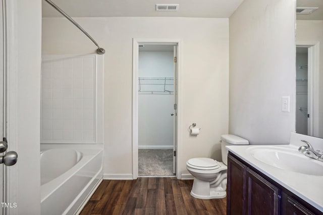 full bathroom with shower / bathing tub combination, toilet, vanity, and hardwood / wood-style flooring