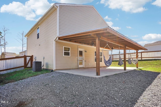 back of property featuring central air condition unit, a patio area, and a yard