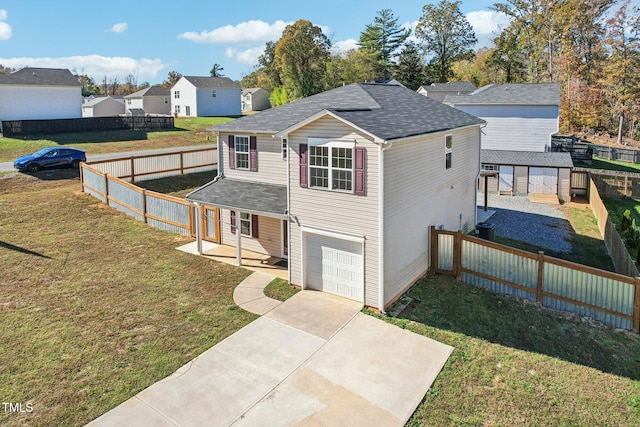 view of front of home with a front yard and a garage