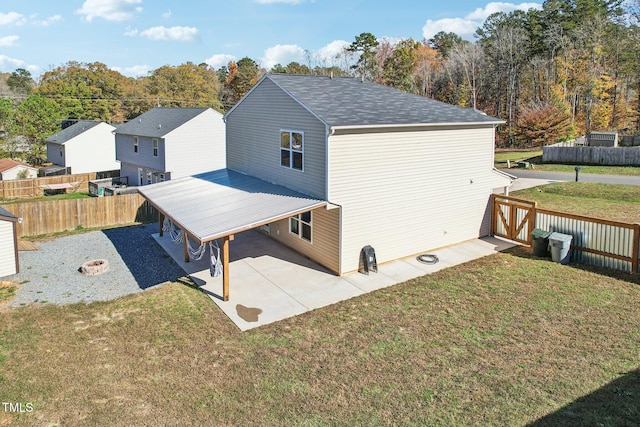 rear view of house featuring a yard, an outdoor fire pit, and a patio area