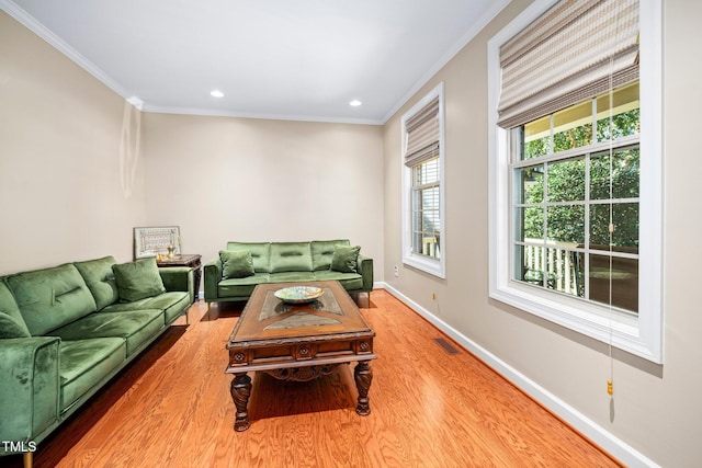 living room with hardwood / wood-style flooring and ornamental molding