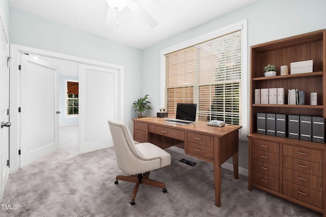 carpeted office with ceiling fan