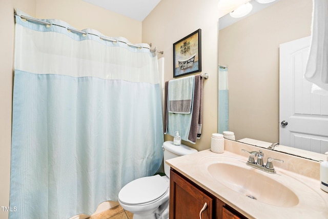 bathroom featuring toilet, tile patterned flooring, vanity, and walk in shower