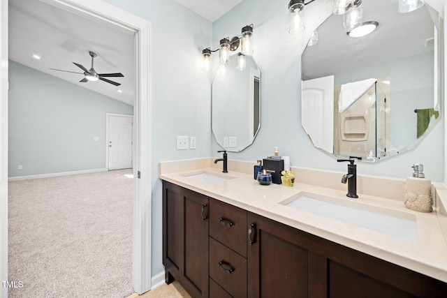 bathroom featuring ceiling fan, vanity, and lofted ceiling