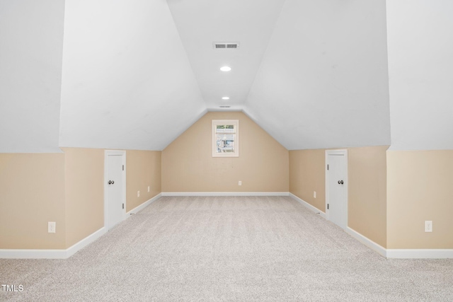 additional living space with light colored carpet and lofted ceiling