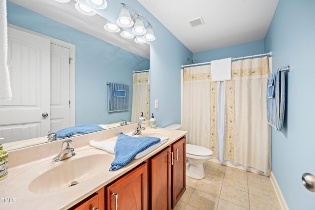 bathroom with toilet, vanity, tile patterned floors, and curtained shower