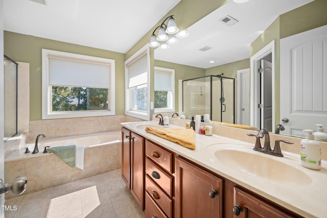 bathroom featuring tile patterned floors, vanity, and plus walk in shower