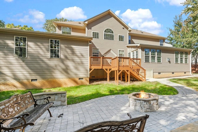 rear view of house featuring a fire pit, a deck, and a patio area