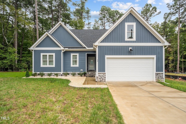 craftsman-style home featuring a front yard and a garage