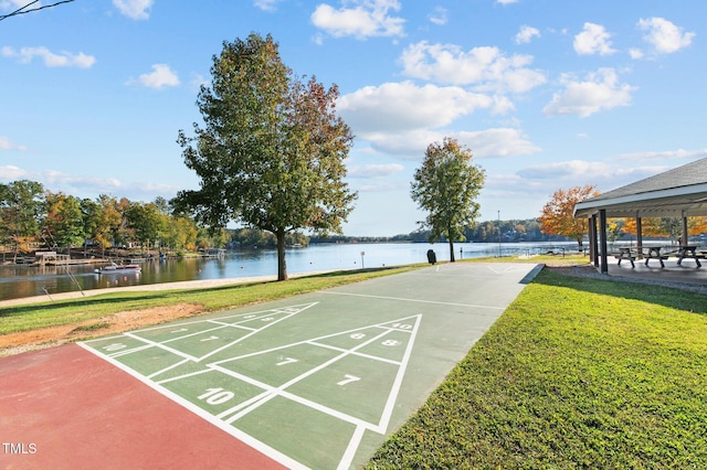 view of property's community with a yard and a water view