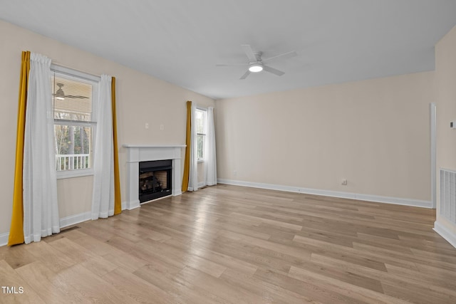 unfurnished living room featuring light hardwood / wood-style floors and ceiling fan