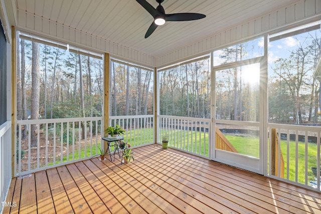 unfurnished sunroom with ceiling fan