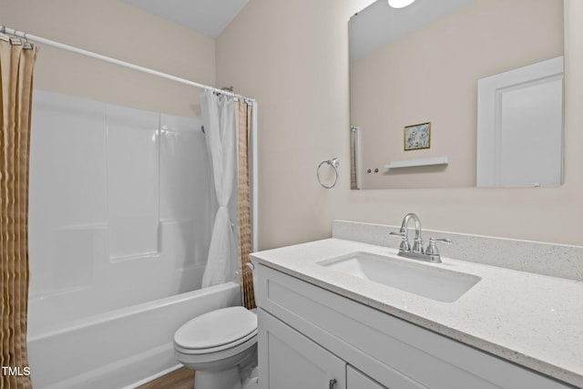 full bathroom with vanity, shower / tub combo, and toilet