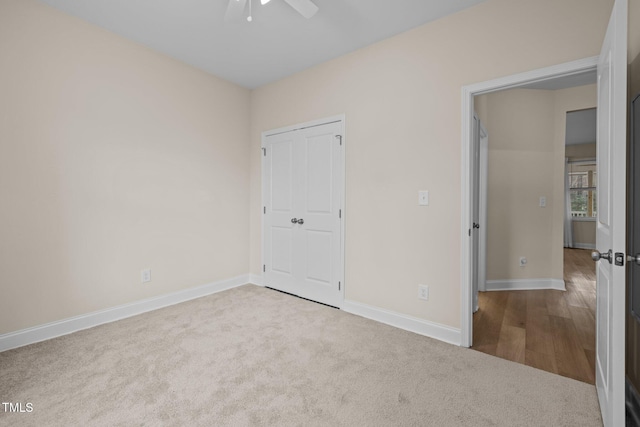 unfurnished bedroom featuring light carpet and ceiling fan