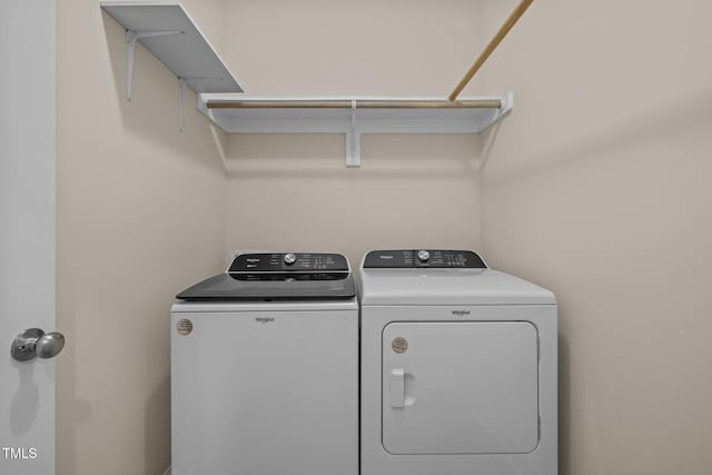 clothes washing area with separate washer and dryer