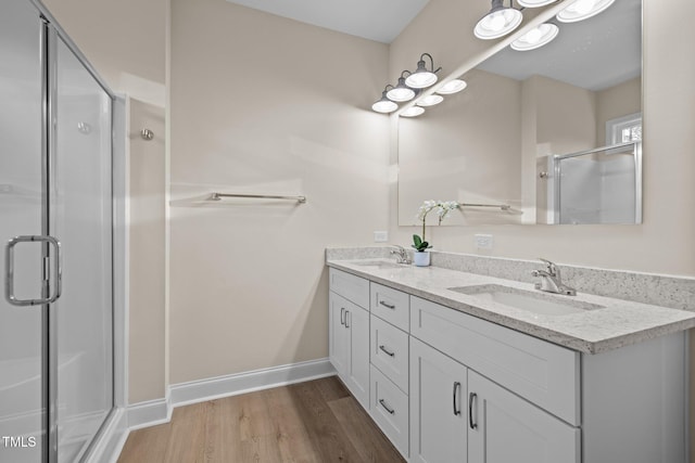 bathroom featuring vanity, a shower with door, and hardwood / wood-style floors