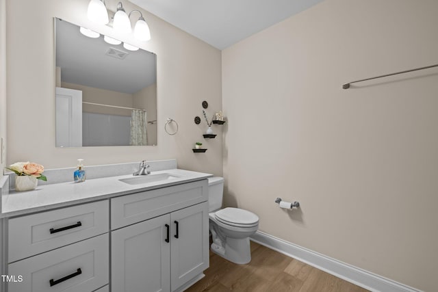 bathroom with a shower with curtain, vanity, toilet, and hardwood / wood-style floors