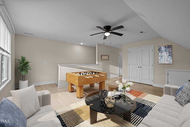 living room with vaulted ceiling, ceiling fan, and light hardwood / wood-style floors