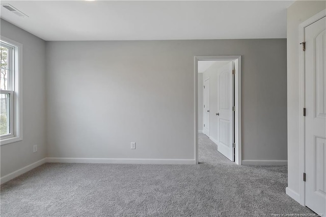 unfurnished bedroom featuring carpet floors, baseboards, and visible vents