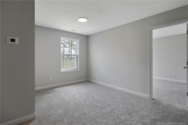 empty room with carpet floors and baseboards