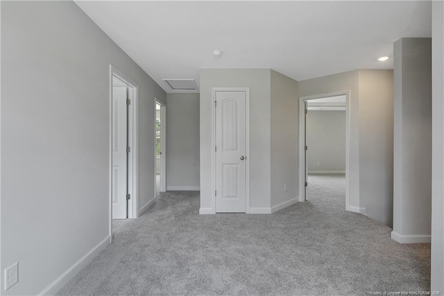 interior space with baseboards, attic access, and recessed lighting