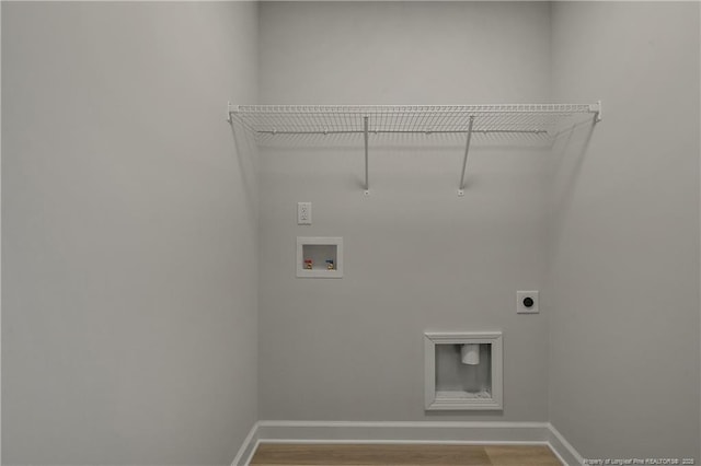 clothes washing area featuring laundry area, wood finished floors, baseboards, washer hookup, and hookup for an electric dryer