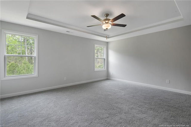 unfurnished room featuring baseboards, a ceiling fan, and a tray ceiling