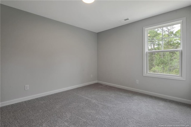 carpeted empty room with baseboards and visible vents