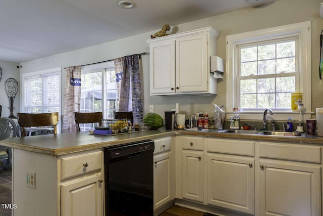 kitchen featuring kitchen peninsula, black dishwasher, white cabinetry, and sink