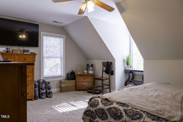 carpeted bedroom with vaulted ceiling and ceiling fan