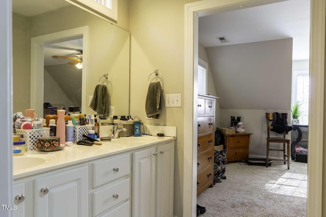 bathroom with ceiling fan, vanity, and vaulted ceiling