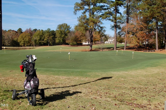 view of home's community with a lawn and golf course view