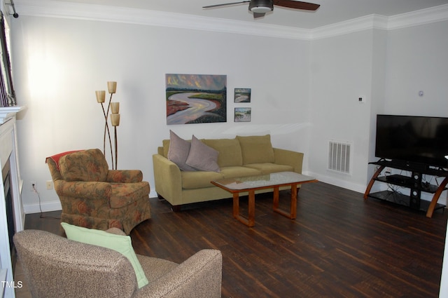 living area featuring visible vents, ornamental molding, wood finished floors, a fireplace, and ceiling fan