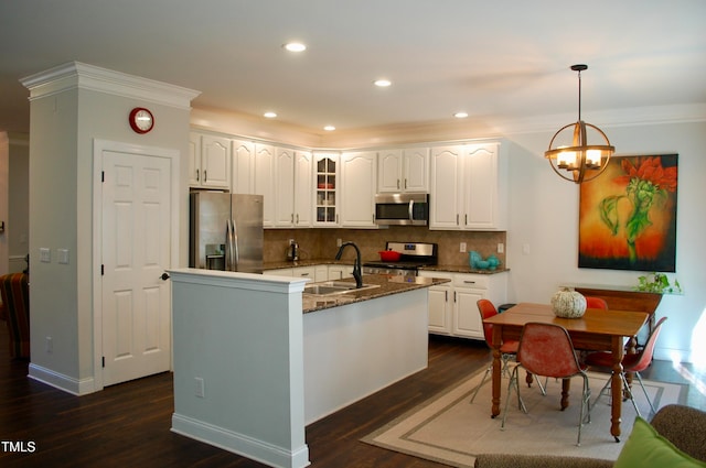 kitchen with decorative backsplash, a sink, dark wood-style floors, stainless steel appliances, and glass insert cabinets