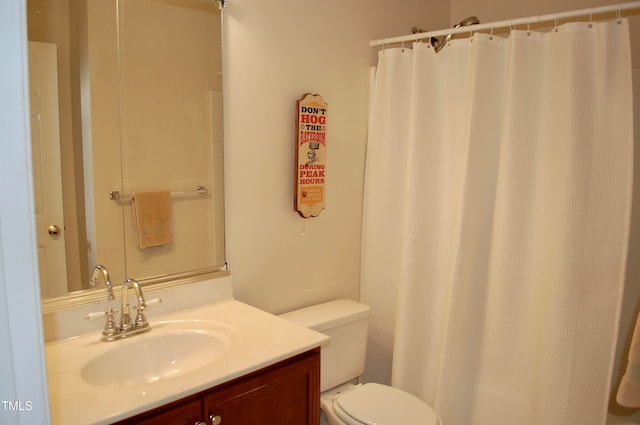 bathroom featuring a shower with curtain, toilet, and vanity