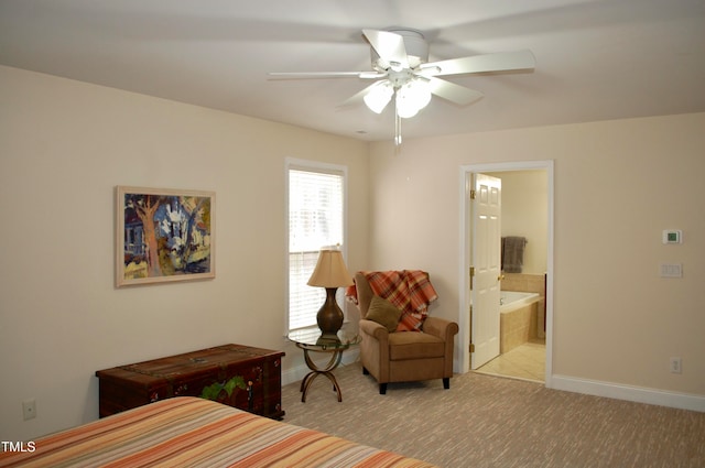 bedroom with baseboards, a ceiling fan, ensuite bathroom, and carpet flooring